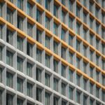 Modern building facade with repeating windows and yellow accents